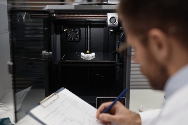 Technician Documenting Printed 3D Dental Prosthesis